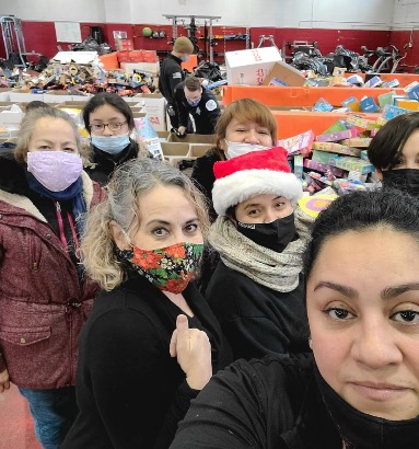 Toys for Tots Program President & Founder Maribel Garcia with Toy for Tots volunteers
